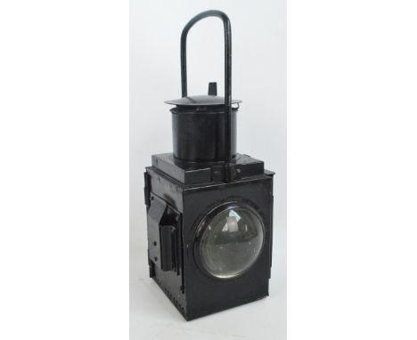 A large black painted railway lantern with fixed loop carrying handle, twin bullseye clear glasses and hinged cover, height 4