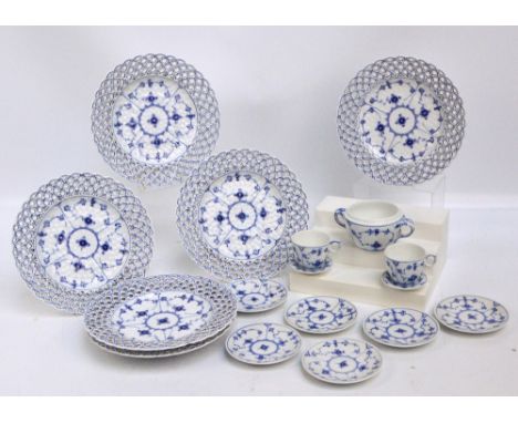 A set of six Royal Copenhagen porcelain plates with blue floral sprays and pierced rims, diameter 23cm, also two coffee cups,