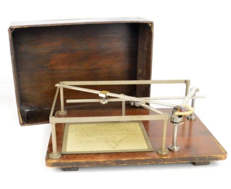 A cased early 20th century planimeter with mounted instructions for use to the base, 60 x 42cm.