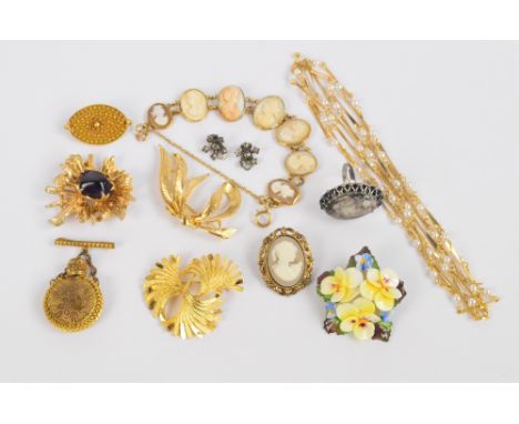 A small collection of various yellow metal costume brooches, a yellow metal and simulated pearl necklace, and a yellow metal 