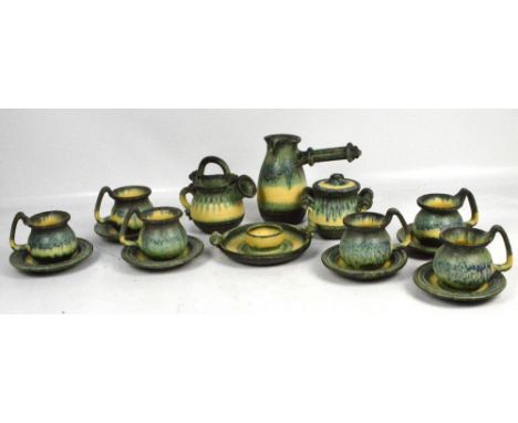 A quantity of green and cream drip ware studio ceramics comprising six cups and saucers, two vessels with spouts, a lidded bo