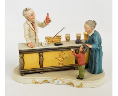 A Capodimonte figure group "The Pharmacy", after R. Guidolin, signed to base, with certificate of authenticity.