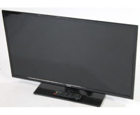 A Polaroid 40 inch television, with black trim and remote control, 
