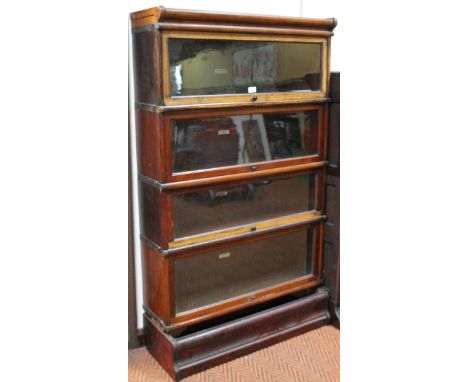 A Globe Wernicke mahogany sectional bookcase, with four sliding glazed doors and a moulded plinth, with associated base, 144c