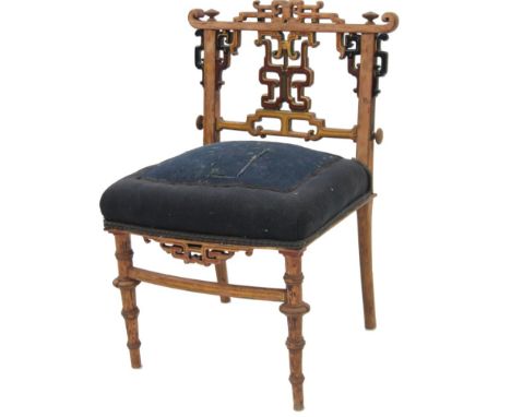 A 19thC Chinese style low seated slipper chair, by Grace, with low stylized scroll back and painted frame with overstuffed se