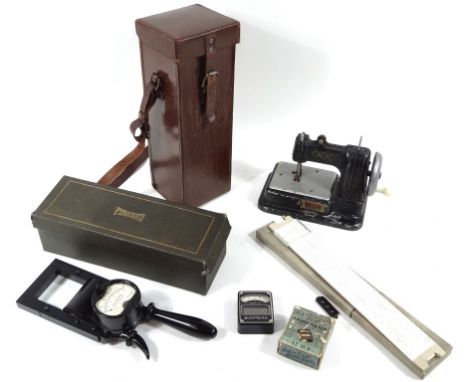 A mid-20thC Vulcan miniature metal sewing machine, with an articulated side handle, with black trim, 16cm high, a PIC slide r