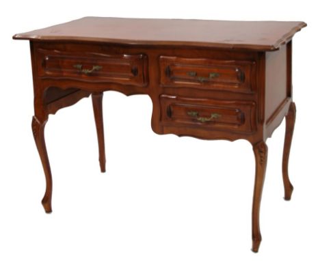 A Chinese hardwood desk, the overhanging serpentine top raised with an arrangement of five frieze drawers, on stylised cabrio