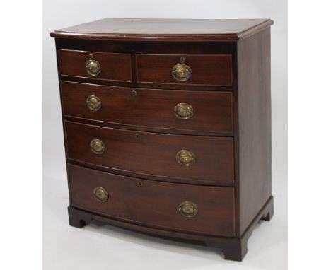 An early 19thC mahogany bow front chest, of two short and three long drawers, each with plate back handles on bracket feet, 1