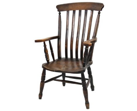 A late 19thC ash and elm comb back grandfather chair, with shaped vertical splats, turned arms, triple ring turned front supp