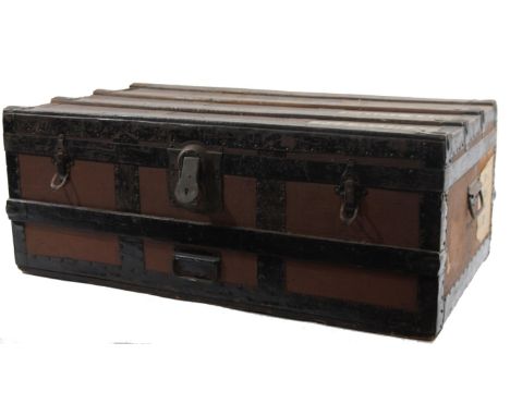 An early 20thC metal bound steamer trunk, of rectangular outline with metal handles and elaborate lock with elaborate escutch