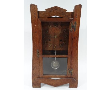 An American oak cased Arts and Crafts wall clock, the square dial bearing Arabic numerals, 8-day movement by The Newhaven Clo