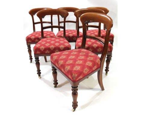 A set of six Victorian mahogany comb back dining chairs, with arched horizontal splats, overstuffed seats and (later) red and