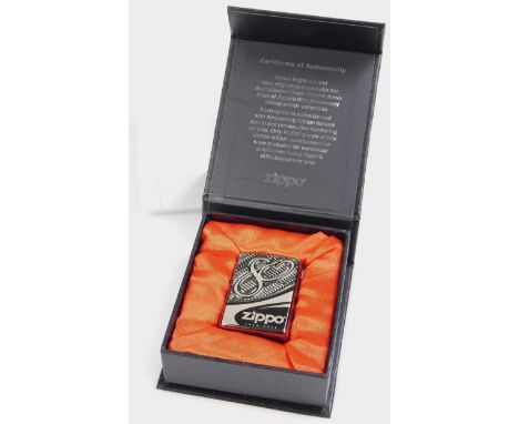 A limited anniversary edition Zippo 1932-2012 lighter, with bright cut decoration 6cm high, with box and outer packaging.