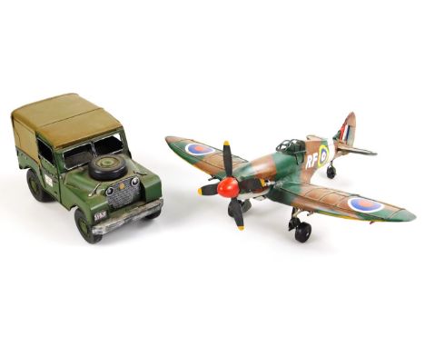 A modern metal ornamental figure, of an army jeep, with Union Jack flag to the door, 15cm high, and a model of a Spitfire, wi