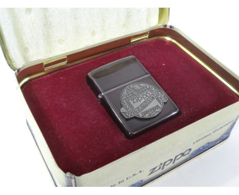 A Zippo 60th Anniversary lighter, 6cm high. (in outer tin)