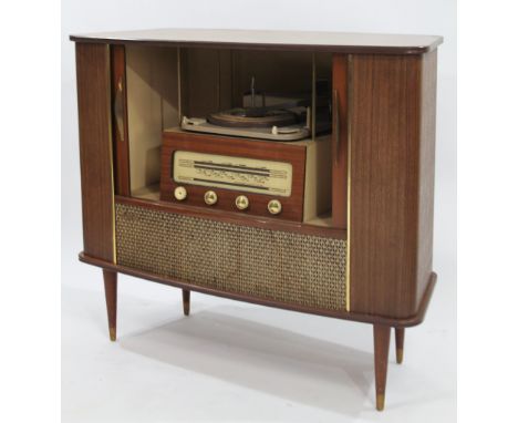 A mid 20thC retro teak cased radiogram, the front opening to reveal an articulated turntable above radio with front tuning kn