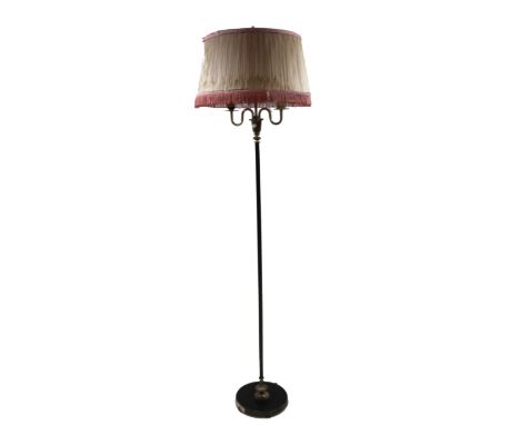 A modern standard lamp, with tasselled shade raised on a cylindrical fluted stem and circular foot, 166cm high
