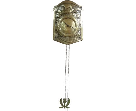 A Glasgow School 'Waggit The Wa' brass clock, the shield shaped dial repoussé decorated with a ship riding the seas, circular