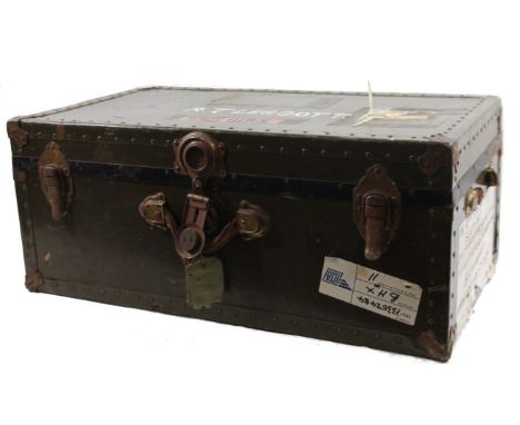 An early 20thC National Vulcanized tin trunk, partially studded, with labels, 32cm H, 82cm W, 43cm D.
