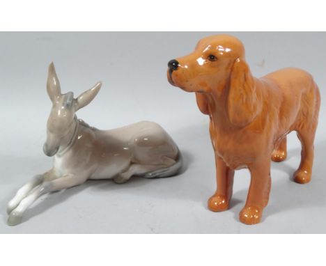 A Beswick pottery cocker spaniel figure Horseshoe Primula, printed marks beneath, 14cm high, and a Lladro figure of a recumbe