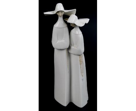A Lladro figure group, of two standing nuns, 33cm H.