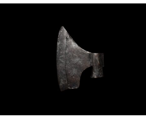 15th-17th century AD. A substantial iron axe-head with pentagonal-section flared socket, broad blade with curved edge, stampe