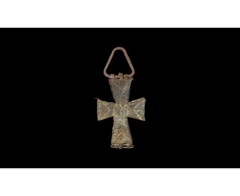 10th-14th century AD. A hollow-formed sheet bronze pendant cross with expanding arms; loop hinge to the lower edge, folded ed