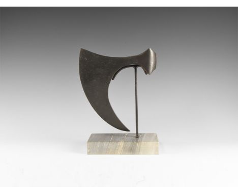 9th-12th century AD. An iron axehead with long, deeply curved blade, short neck, socket with triangular wings above and below