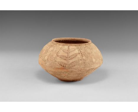 3rd millennium BC. A squat biconvex ceramic jar with basal ring and low everted rim; painted panels of geometric and tree mot