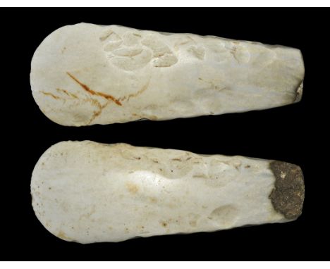 Neolithic, 5th-4th millennium BC. A very finely made polished axe of thick-butted form with convex, almost semi-circular, cut