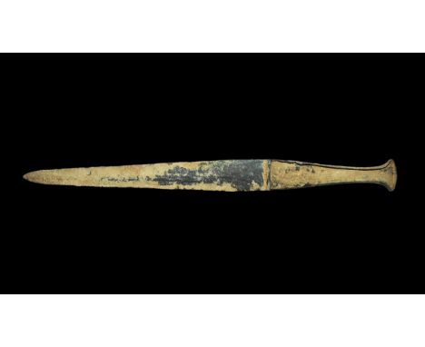 13th-6th century BC. A large bronze flange-hilted dagger with slender leaf-shaped two-edged blade, hollow grip with socket to