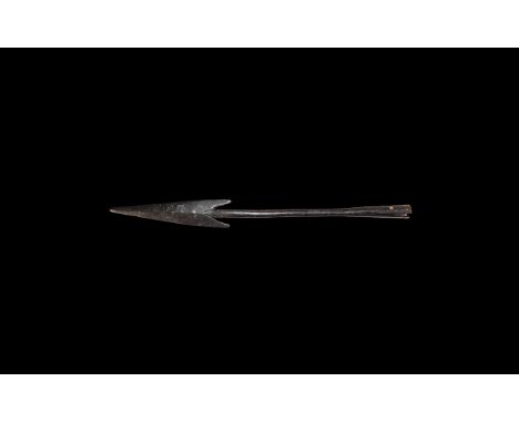 5th-6th century AD. An iron spearhead comprising a slender shank with expanding split socket below, triangular blade with poi