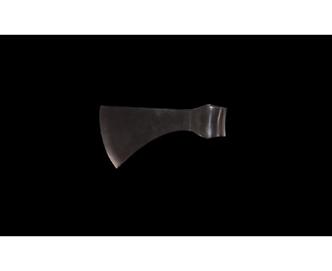 9th-12th century AD. A substantial iron axehead with long blade, gently curved edge, round socket with lateral spurs above an