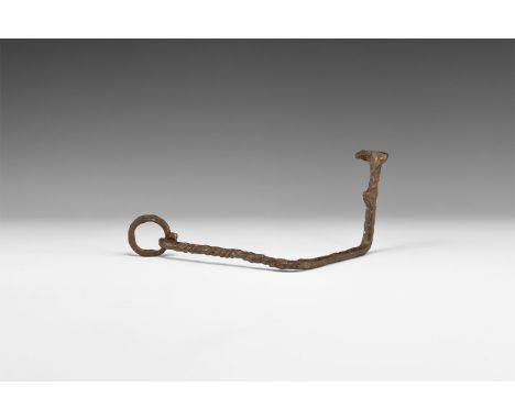 Late 1st millennium BC. A hand-forged iron hook-key with twisted upper shank, two right-angled bends and three securing lugs;