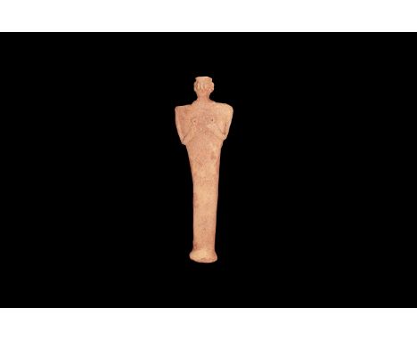 2nd millennium BC. A ceramic idol figurine with elliptical-section base rising to flat-section upper body, depicting a standi