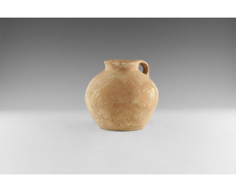 4th-3rd millennium BC. A large thin-walled ceramic jar with bulbous body, broad shoulder, raised and flared rim, single loop 