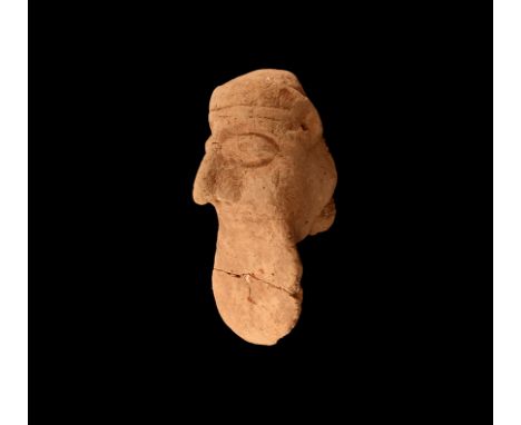 7th-6th century BC. A ceramic head of a male with headband across the brow, lentoid eyes, ears pierced, large, prominent nose