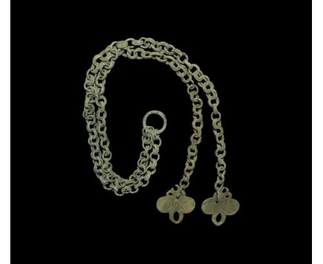 11th-12th century AD. A set of decorative chain comprising: a pair of equal trefoil-shaped finials, each decorated with two g