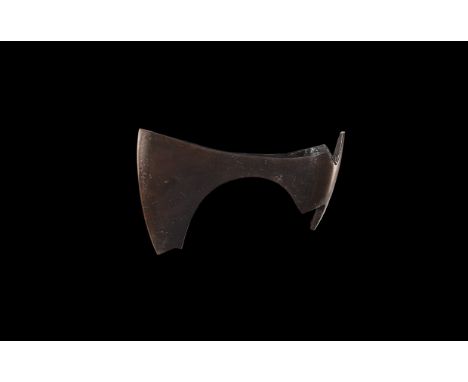 9th-11th century AD. An iron axehead with triangular-section blade, narrow neck widening to a broad bevelled edge with square