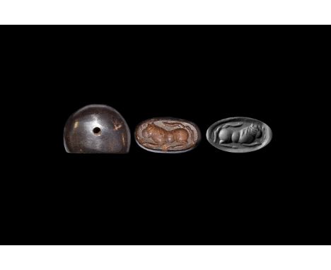 Early 1st millennium AD. A haematite stamp seal engraved with a reclining lion.   11.24 grams, 22mm (1"). UK art market, acqu