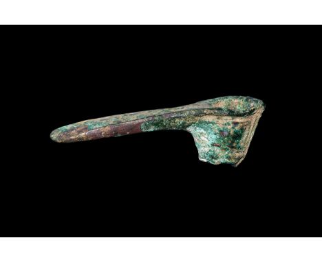 13th-6th century BC. A bronze adzehead with short tubular socket and flared blade, ribbed detailing to the upper socket, vert