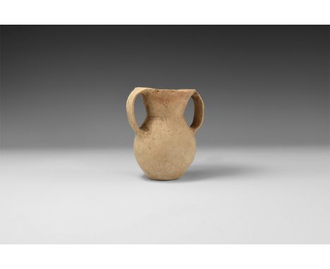 3rd millennium BC. A terracotta vessel with bulbous body, conical neck, two lateral strap handles.   190 grams, 11.5cm (4 1/2