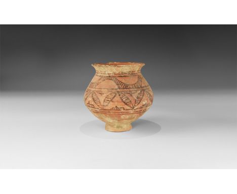 3rd millennium BC. A squat ceramic jar, biconical in profile with flared foot and everted rim, two bands with undulating hatc