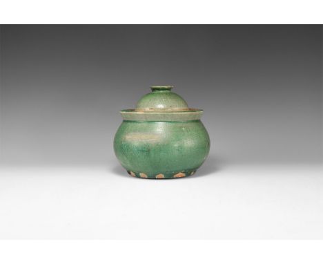 Ayutthaya Kingdom, 1351-1767 AD. A green glazed Sangkhalok Celadon ware pot with flared rim, bulbous body and wide base; dome