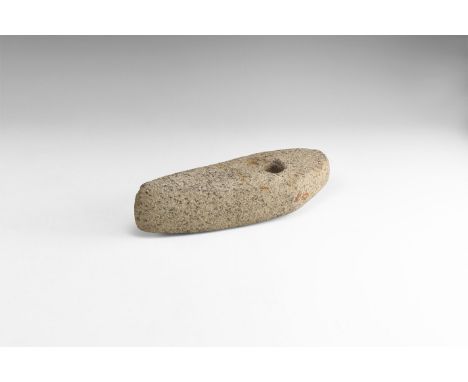 Neolithic, 5th-3rd millennium BC. A large boat-shaped pecked and ground diorite axehead with square butt and round perforatio