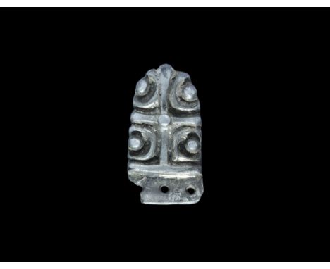 10th-11th century AD. A silver-gilt tongue-shaped strap end with decorative elements in high relief comprising a cross with c