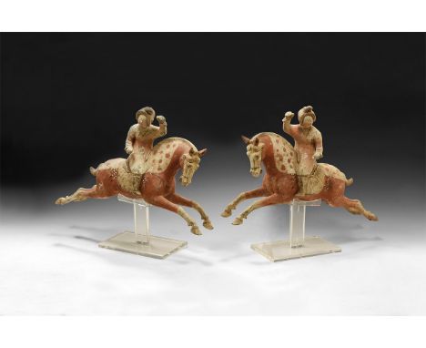 Tang Dynasty, 618-907 AD. A pair of ceramic figure of a leaping horses, the bodies decorated in red paint with spots to the m