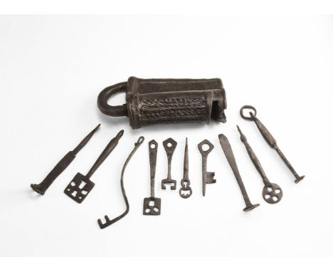 9th-11th century AD. A mixed iron group comprising: a barrel lock with flange to the rear, faceted panels of lattice ornament