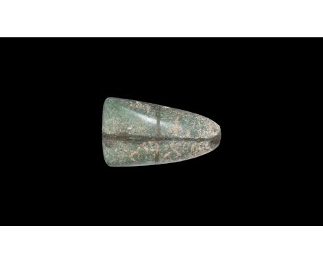 Neolithic, 6th-5th millennium BC. A finely polished green jadeite axe with oval section, tapered sides, rounded butt with sli