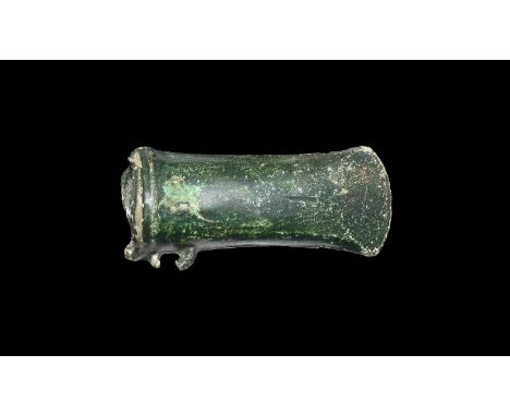 13th-9th century BC. A hollow-formed bronze socketed axehead, lentoid in plan with double rib to the mouth, remains of latera